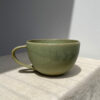 Green ceramic cup on the table